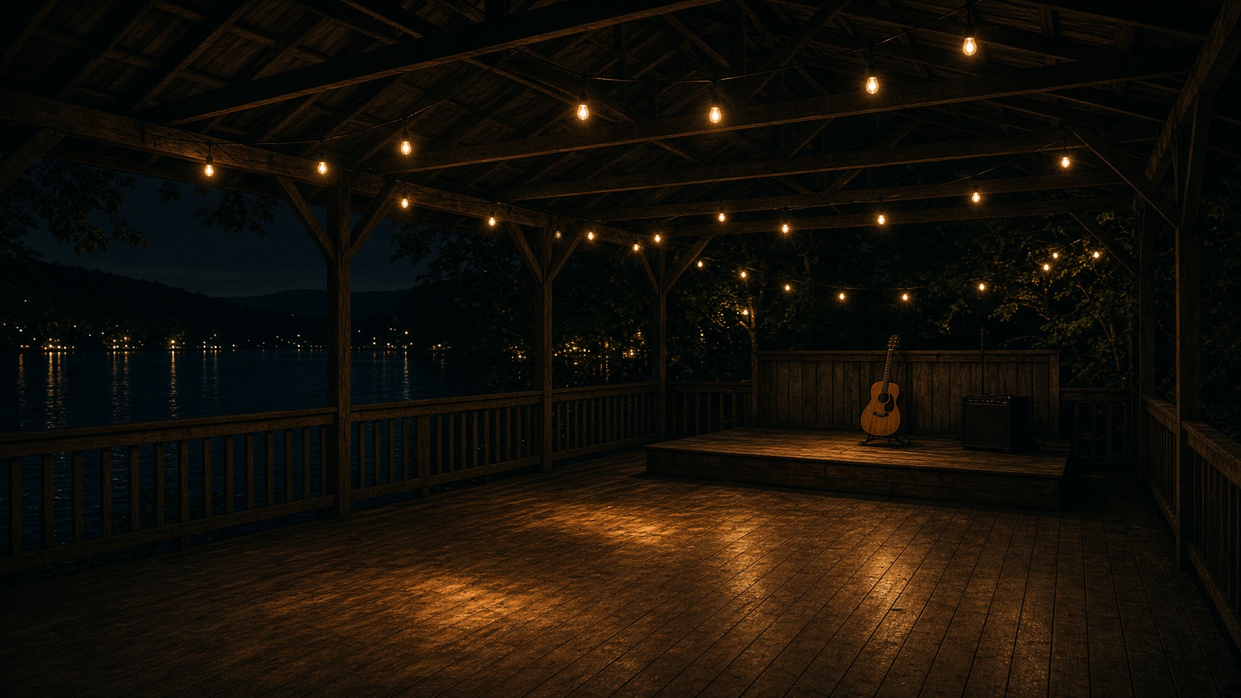 A lakeside pavilion stage under string lights.